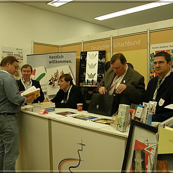 At the stand of the German Chess Federation: Christoph Pragua with Dirk Jan ten Geuzendam and Jewgeni Barejew