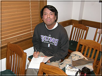 Frisco Del Rosario autographing his Morphy textbook.